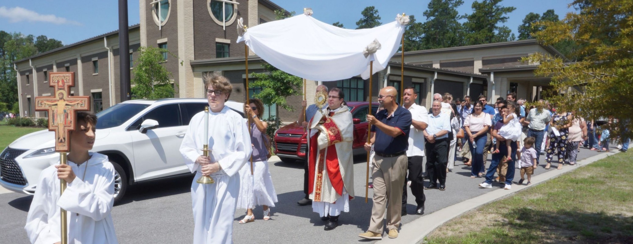 Fr. Pablo leading the congregation in a parade outside of the church